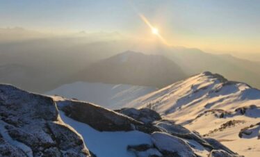 Kedarkantha summit sunrise view with snow covered Himalayan peaks in Uttarakhand