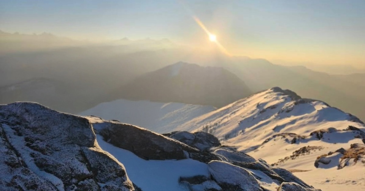 Kedarkantha summit sunrise view with snow covered Himalayan peaks in Uttarakhand