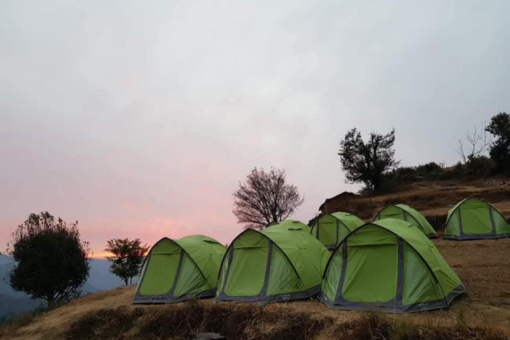 Nag Tibba campsite with tents under starry sky in Uttarakhand Himalayas