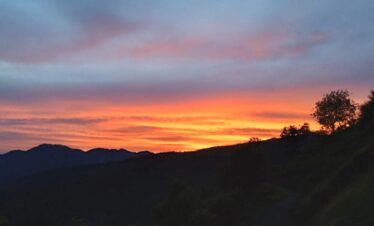 Nag Tibba sunset view with golden Himalayan peaks and campsite in Uttarakhand