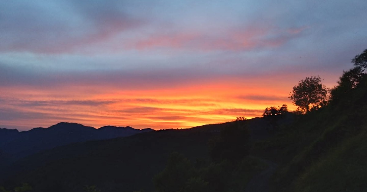 Nag Tibba sunset view with golden Himalayan peaks and campsite in Uttarakhand